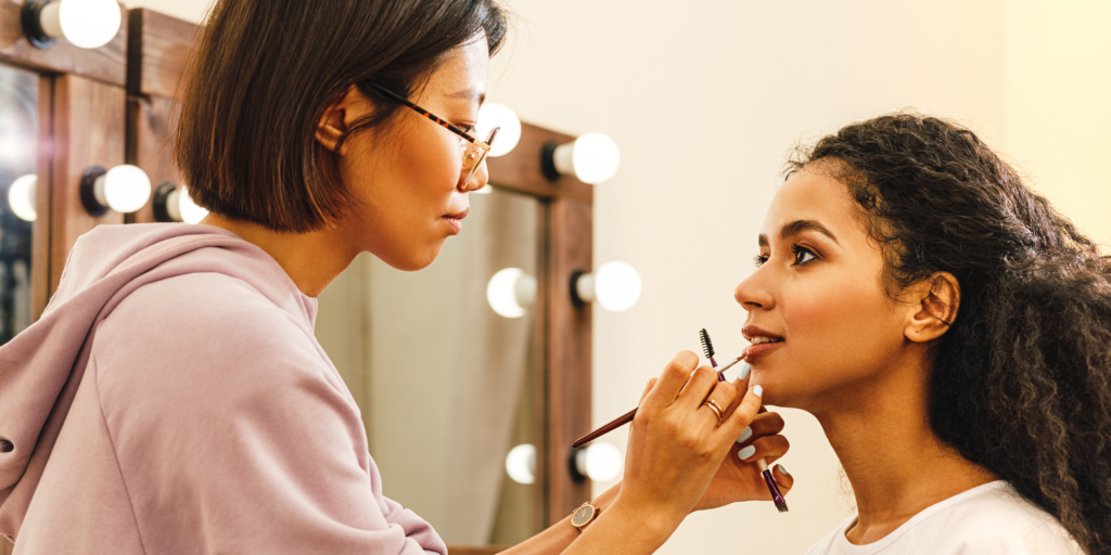 A makeup artist applying makeup on a client