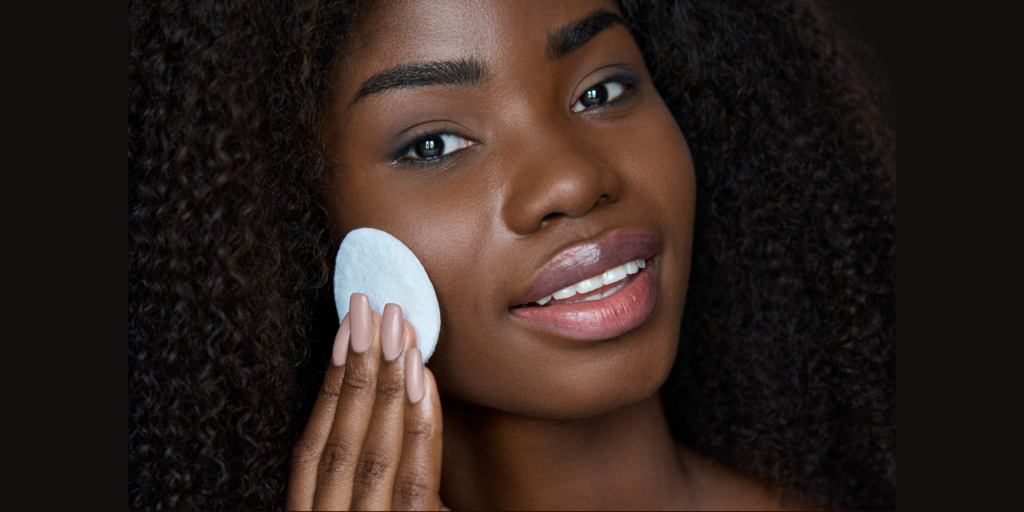 Image of a woman removing makeup with a pad