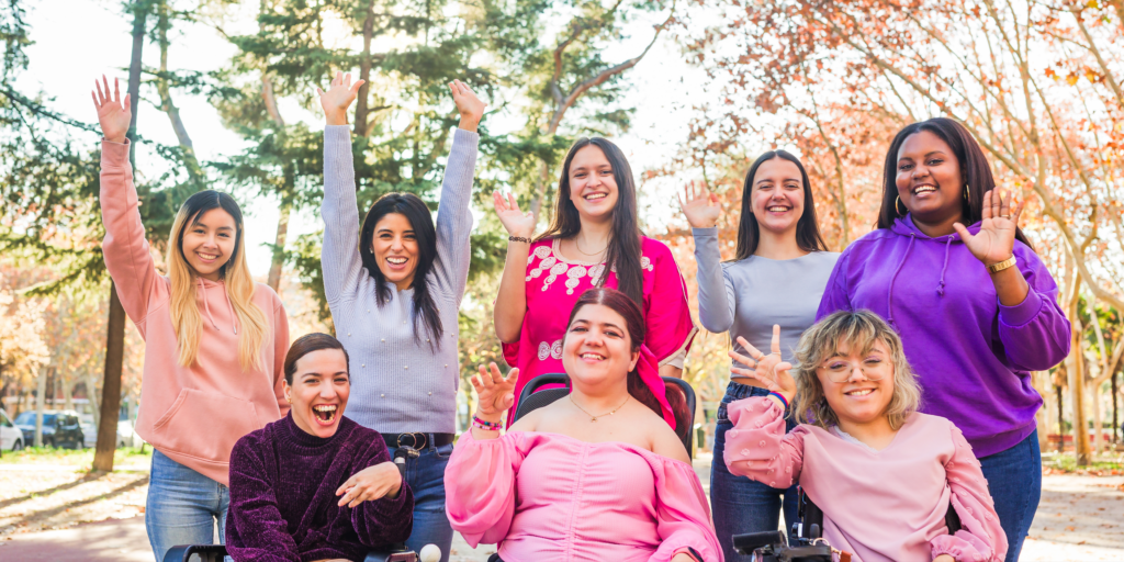 photo of 8 diverse women all differently abled, smiling 